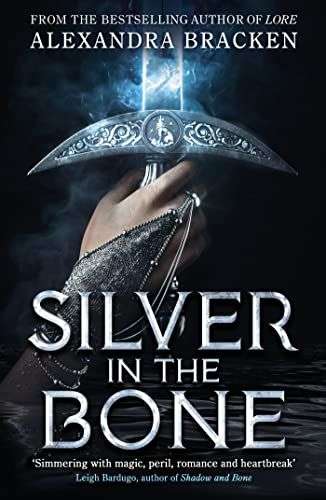 The front cover for Silver in the Bone by Alexandra Bracken. The front cover shows a woman's hand holding a sword coming out of the darkness.