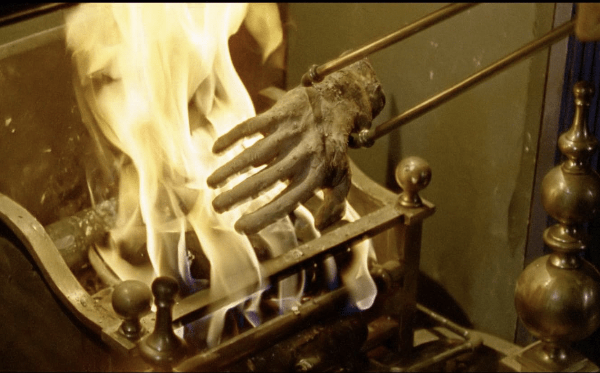 A scene from Dr Terror's House of Horrors shows a disembodied hand being put into a fire