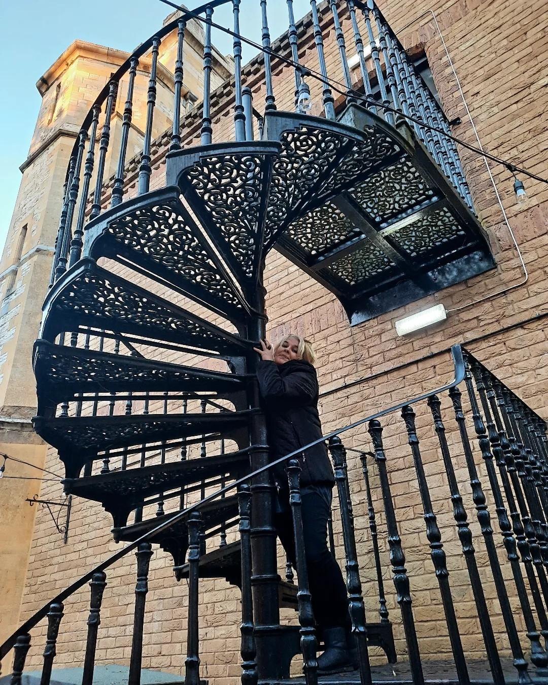 Tracy Fahey on an external spiral staircase