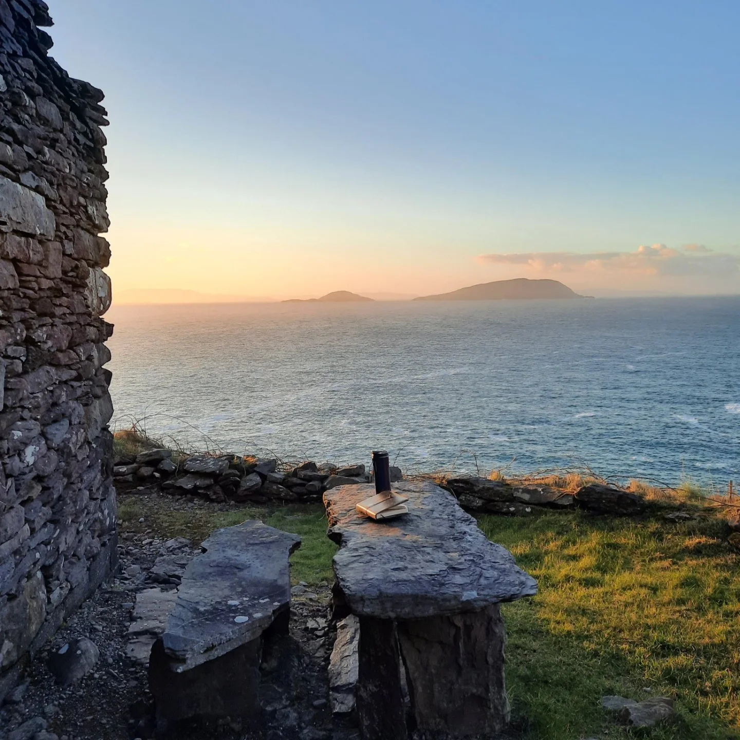 Tracy's writing spot while on the Cill Rialaig Artist Retreat: an old stone wall on a clifftop overlooking the ocean