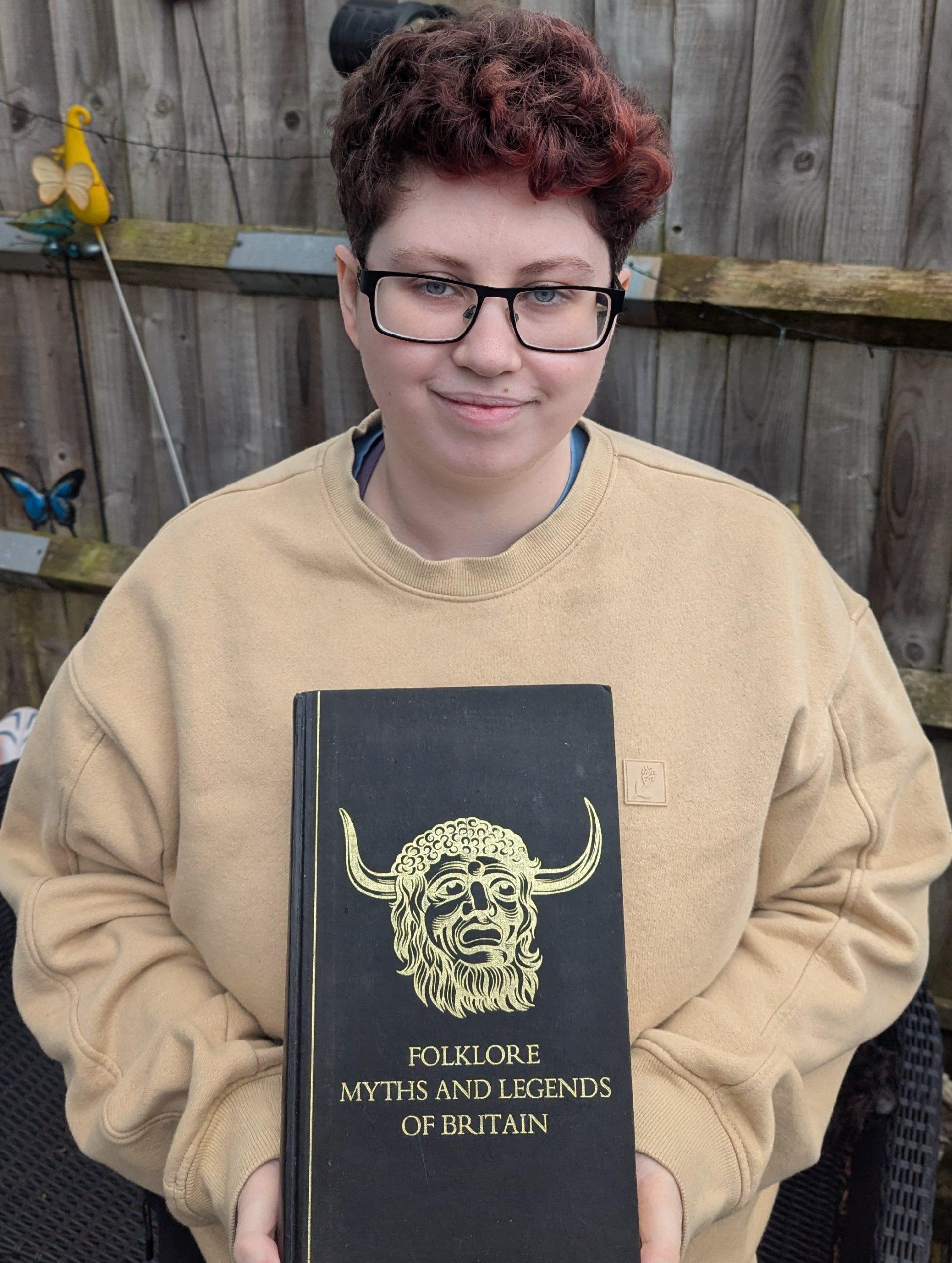 Han Noss holding the Reader’s Digest published Folklore, Myths and Legends of Britain, a family hand-me-down