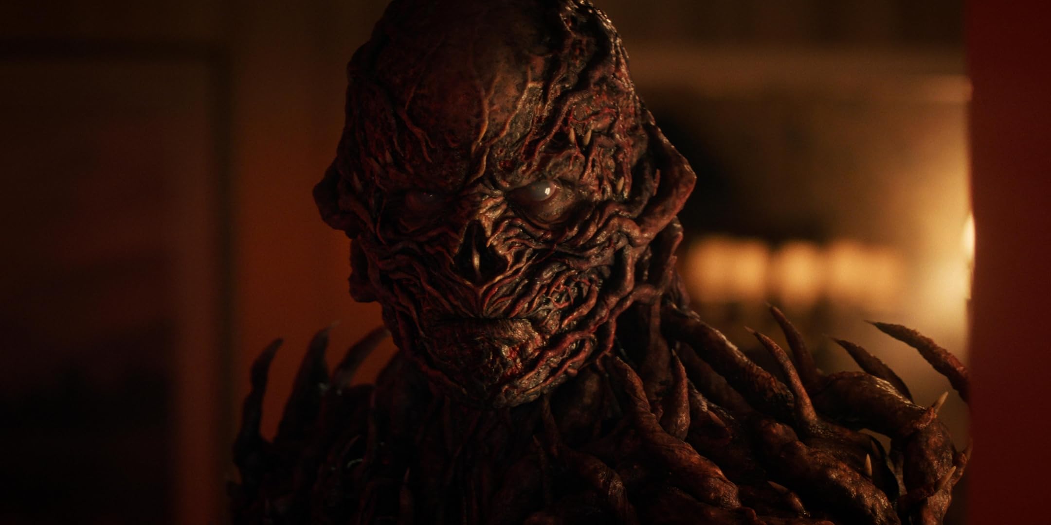 A demonic creature looks at the camera