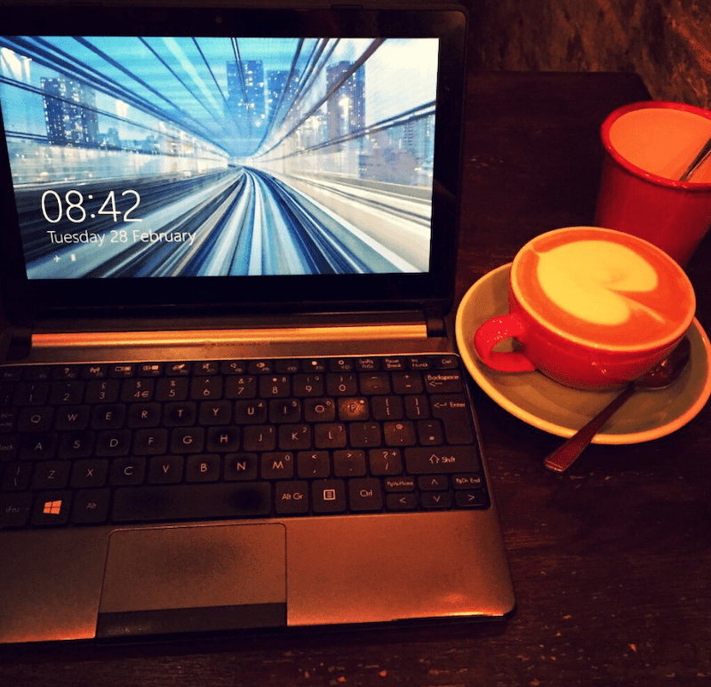A laptop and a coffee
