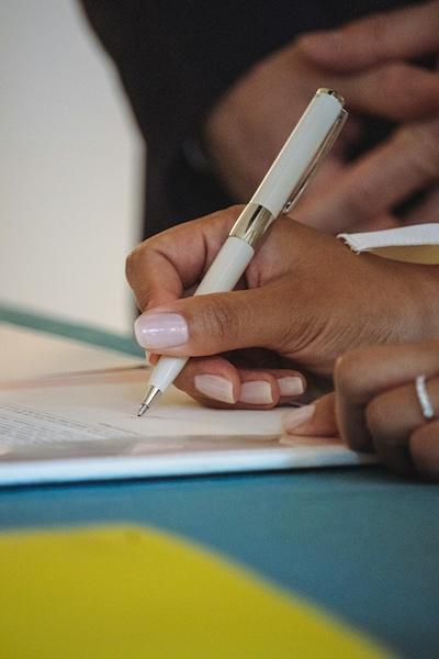 Close-up of a hand signing a contract