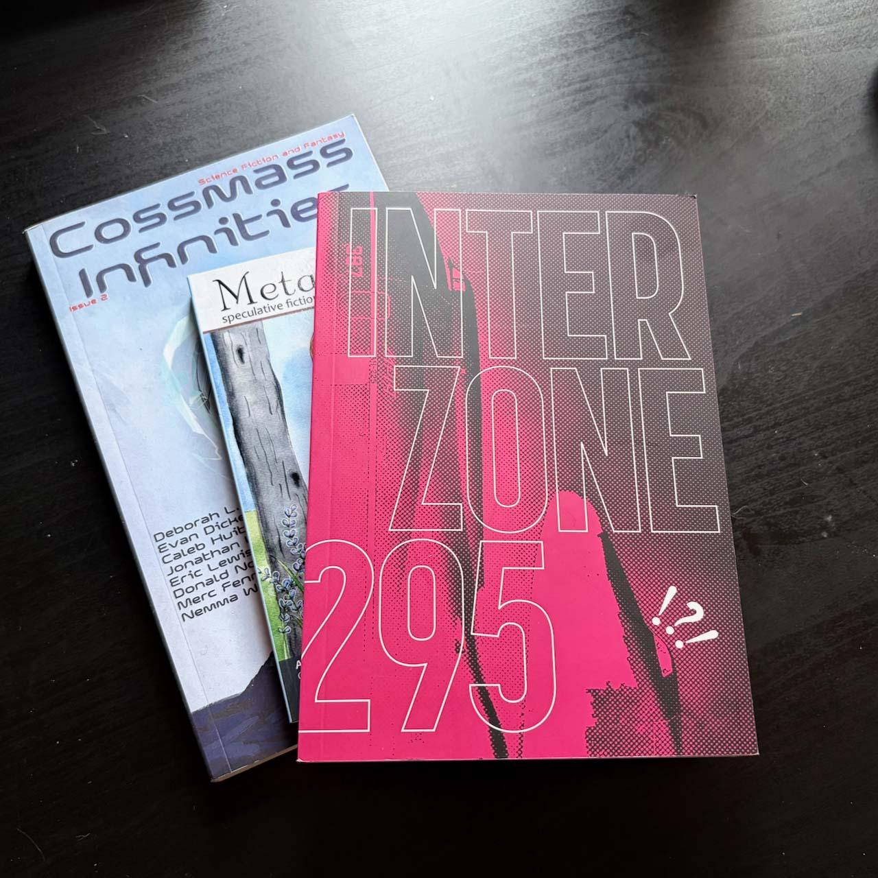 Three magazines spread on a table, the most visible is Interzone.