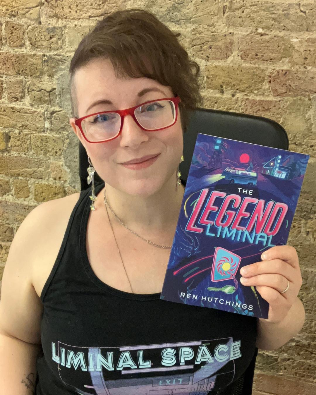 Author Ren Hutchings with their novella, The Legend Liminal