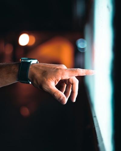 A man's hand points at a light box