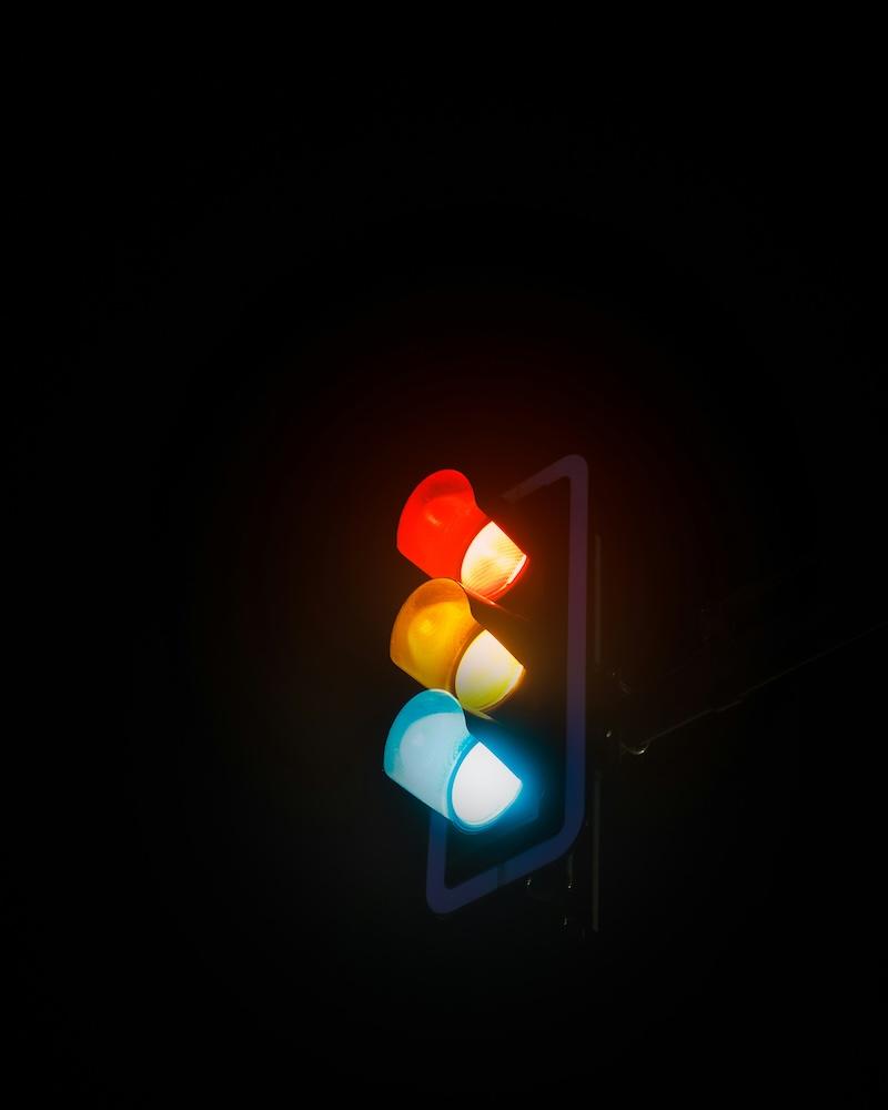 A traffic light lit up in the dark