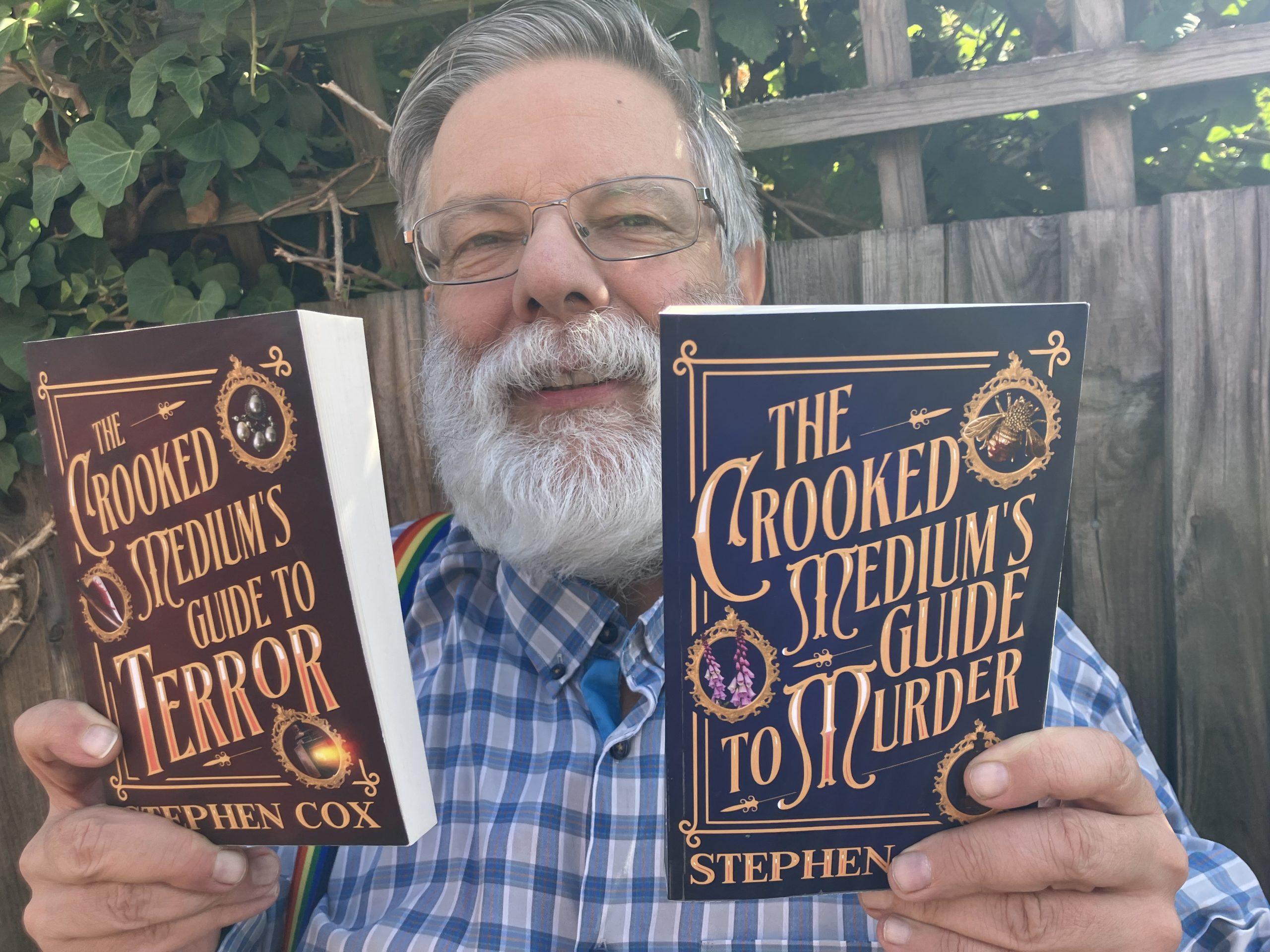 Stephen Cox holding copies of his two books