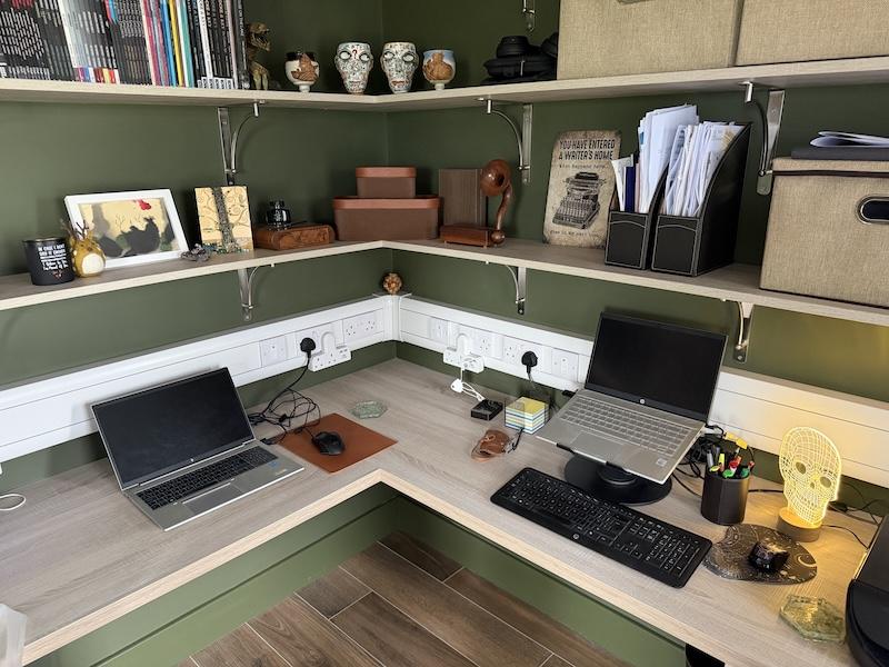 A corner desk with shelving above